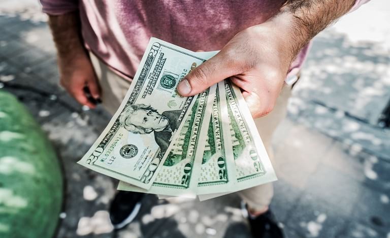 Person handing over cash to another person